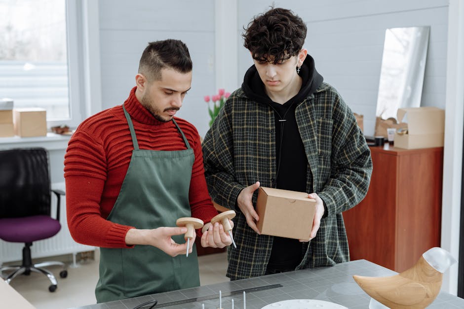 Two men reviewing product. You can outsource Product Support to Taptwice Media and boost your productivity.